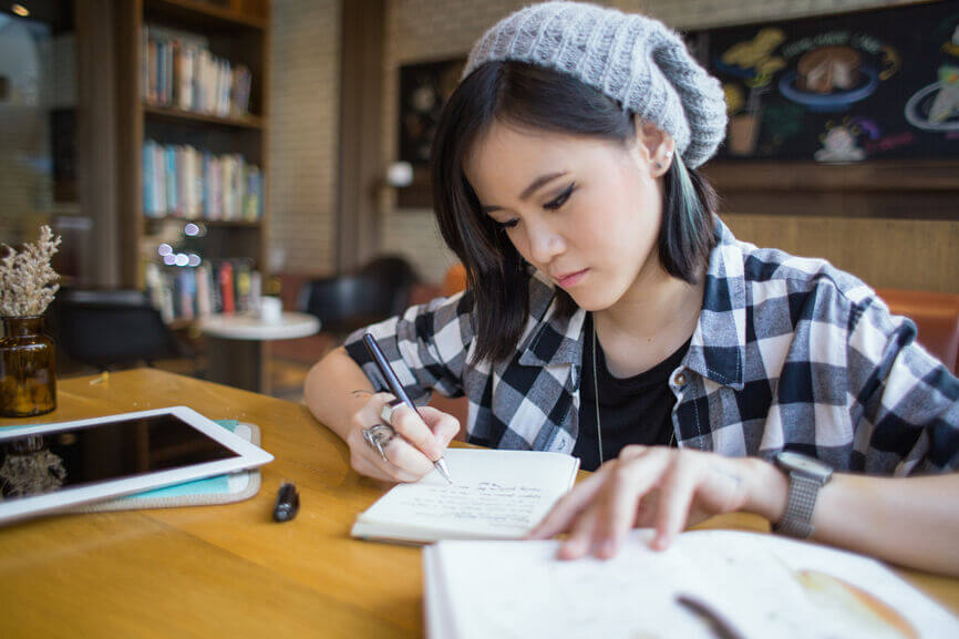homeschooler planning high school curriculum with coffee and pink flowers